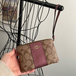 Coach wristlet- never used! Still has inside wrapping. Perfect condition